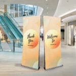 Double sided roller banners for multi-angle graphics view